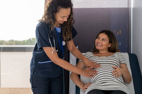 Friendly midwife checks fetal position